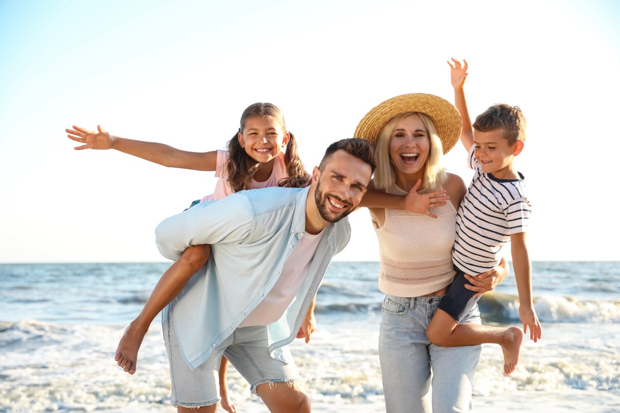 Happy family on beach near sea